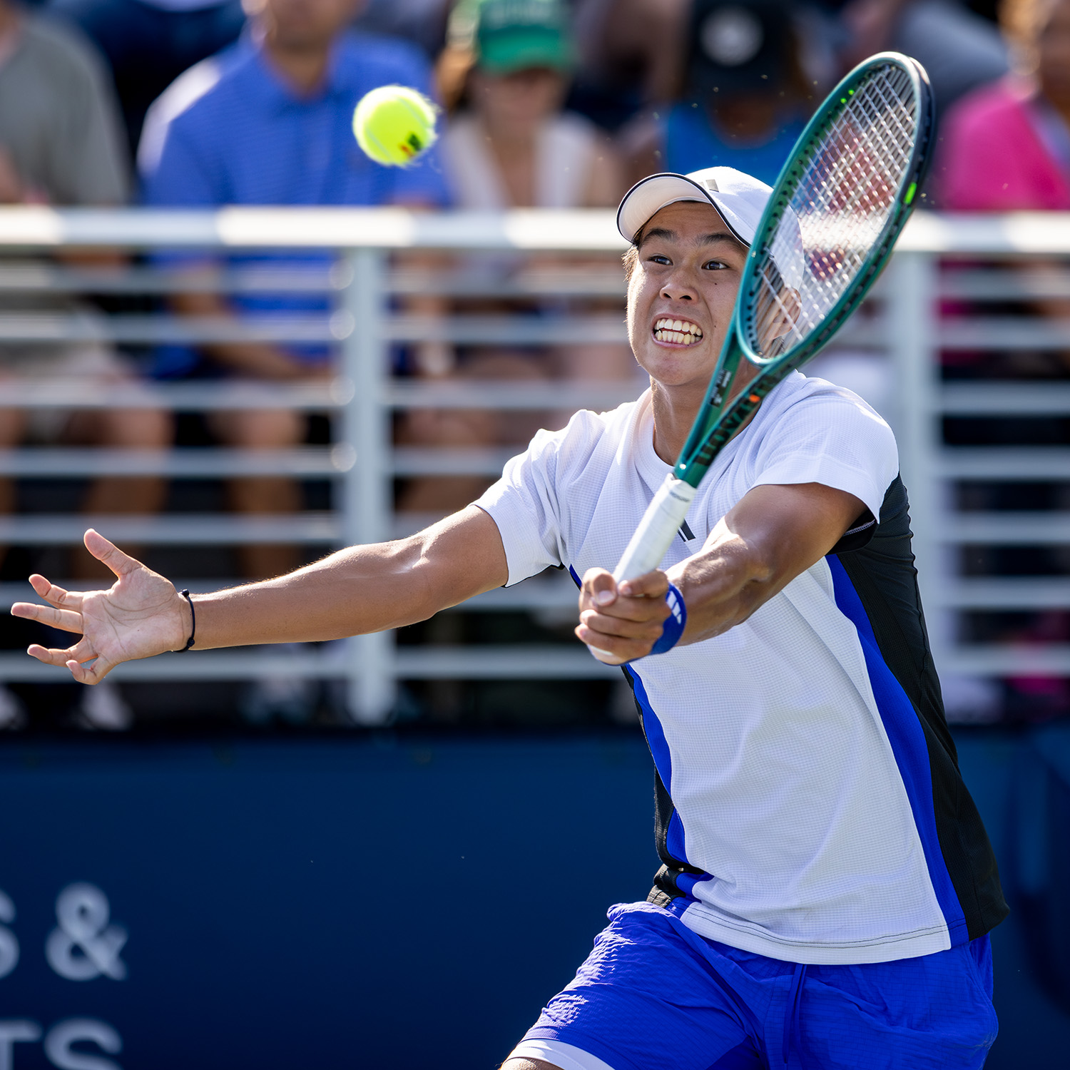 Learner Tien hitting a forehand ball with a Wilson racquet during a US Open 2024 tennis match