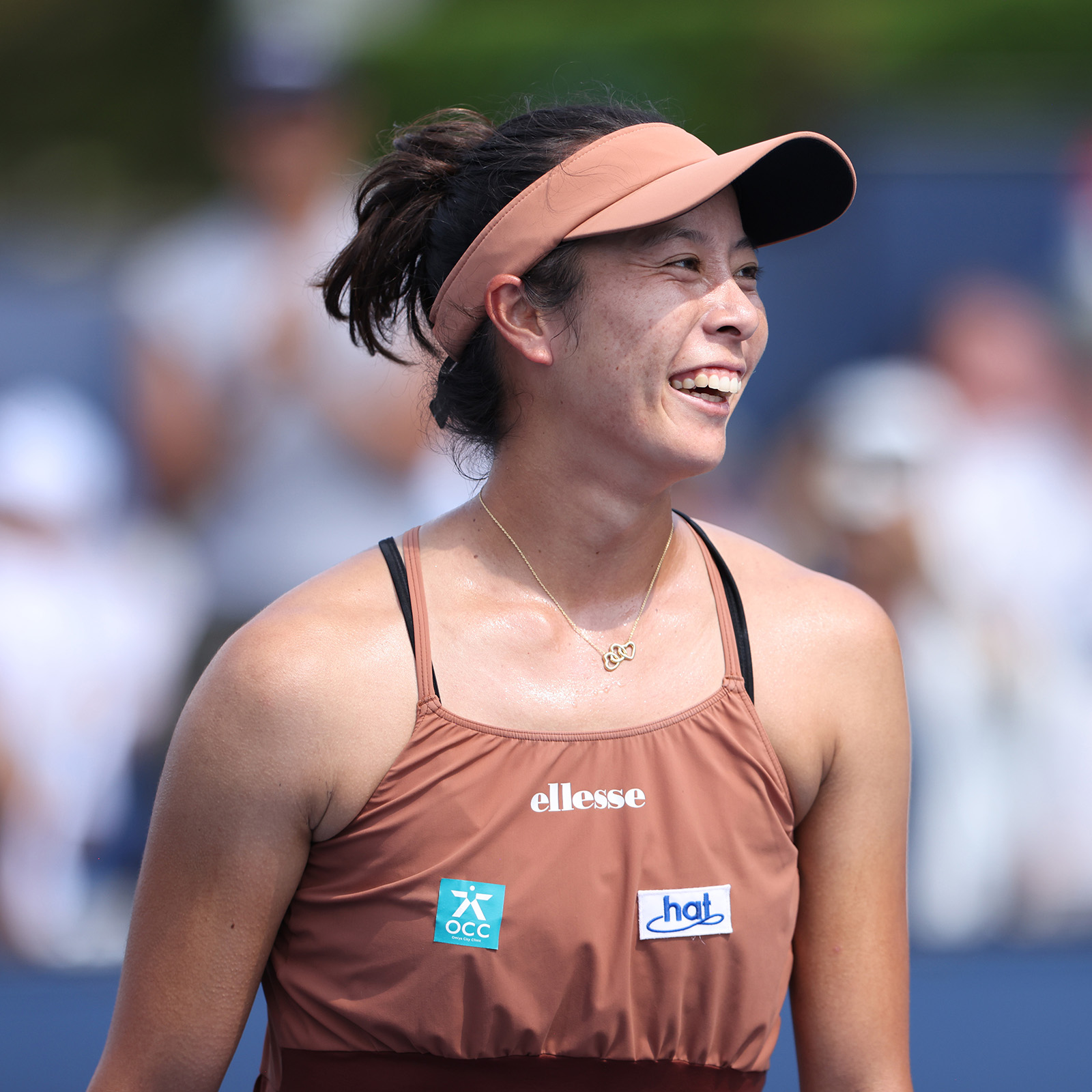 Ena Shibahara smiling and looking at the crowd after winning her first Grand Slam singles main draw match at the US Open in 2024.