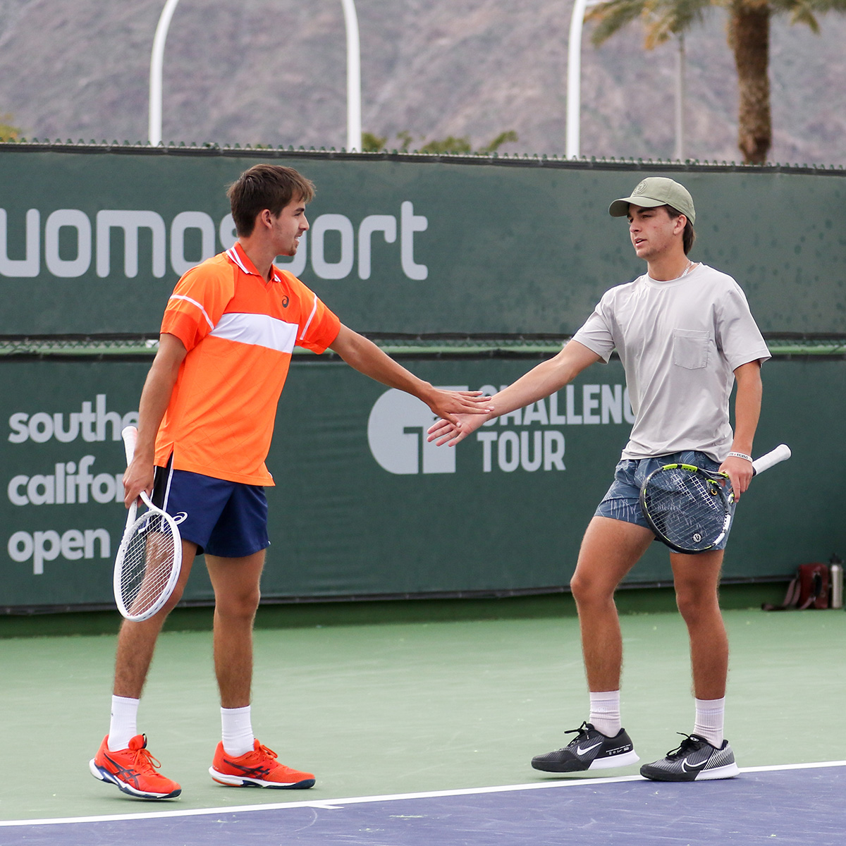 Zach and Trevor Svaja high five during a doubles match at Indian Wells Tennis Garden