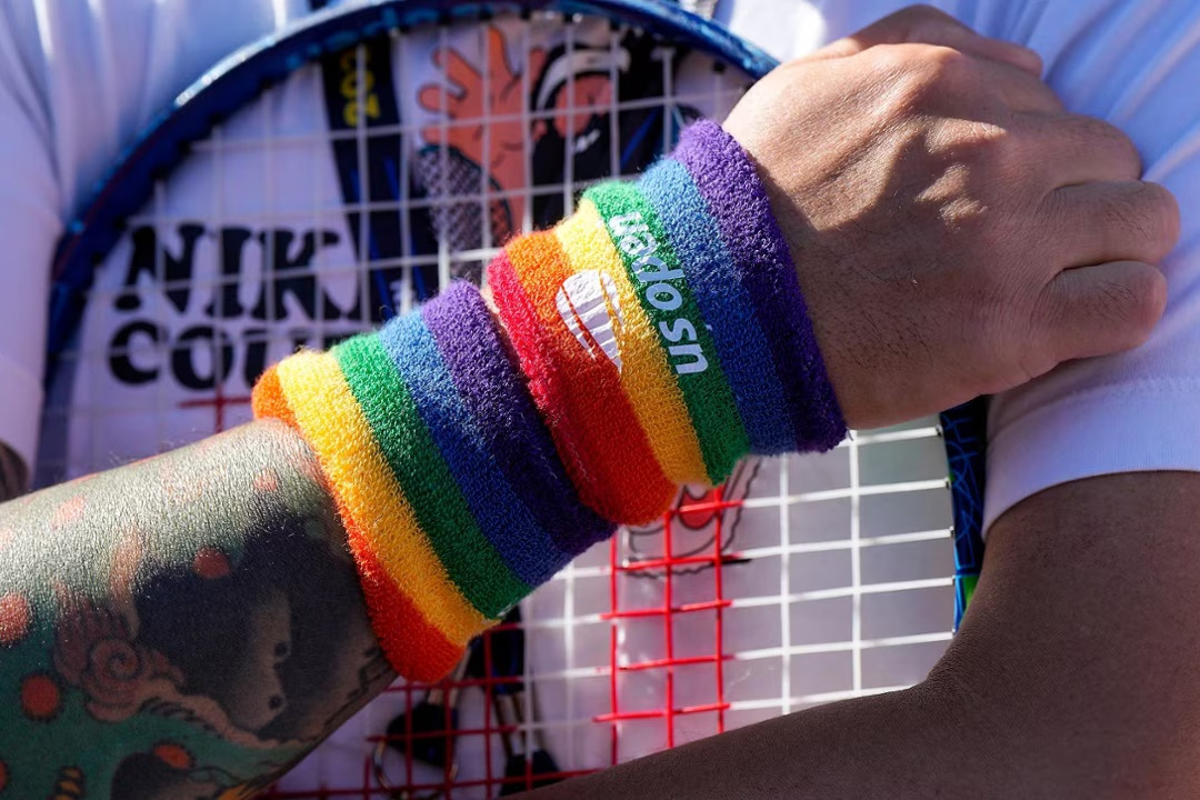 US Open celebrates LGBTQ+ community at Open Pride. Man wearing a rainbow wristband.