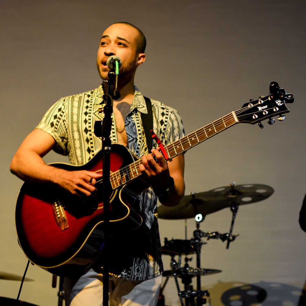 Tyler Parks playing the guitar and singing