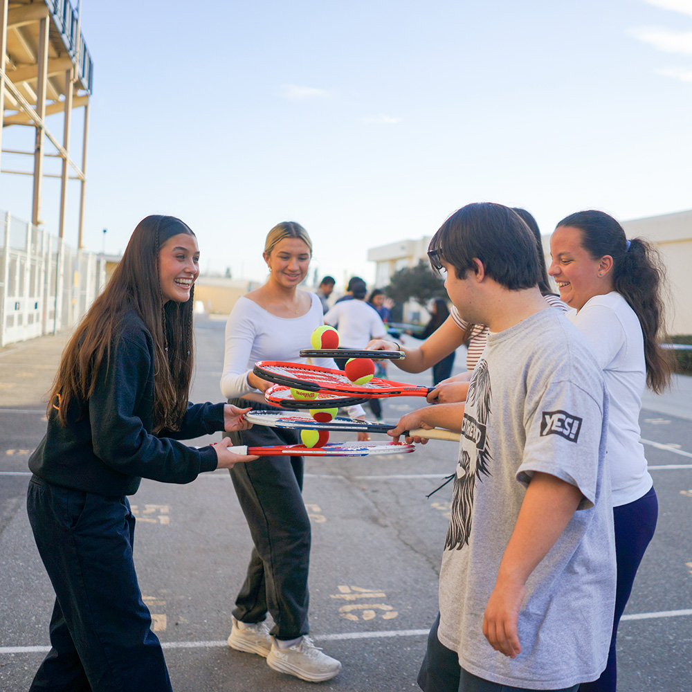 Angie Del Gaudio practicing tennis drills with neurodivergent kids