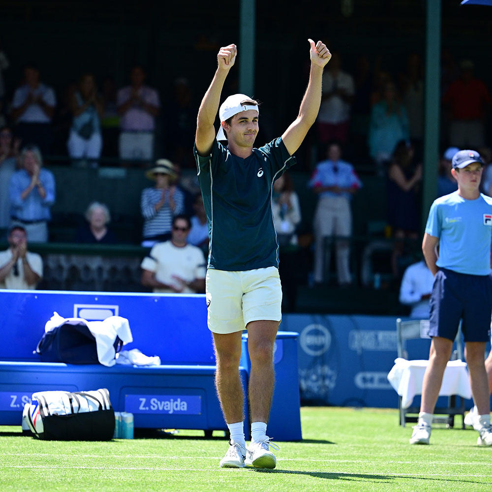 Zach Svajda raises both thumbs in celebration on the grass court after winning the ATP Challenger 125 title in Newport, Rhode Island.