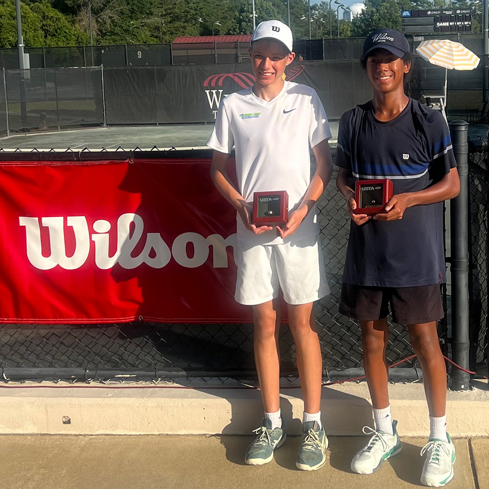 Kensho Ford and Joshua Dolinsky smiling with their USTA Gold Balls after winning the Boys' 16s title at the USTA National Clay Court Championships in Dothan, Alabama.