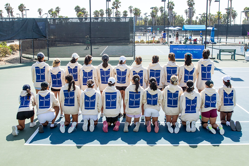 Team SoCal at Billie Jean King Girls’ 16s and 18s National Championships wearing Team SoCal sweatshirts on the tennis court