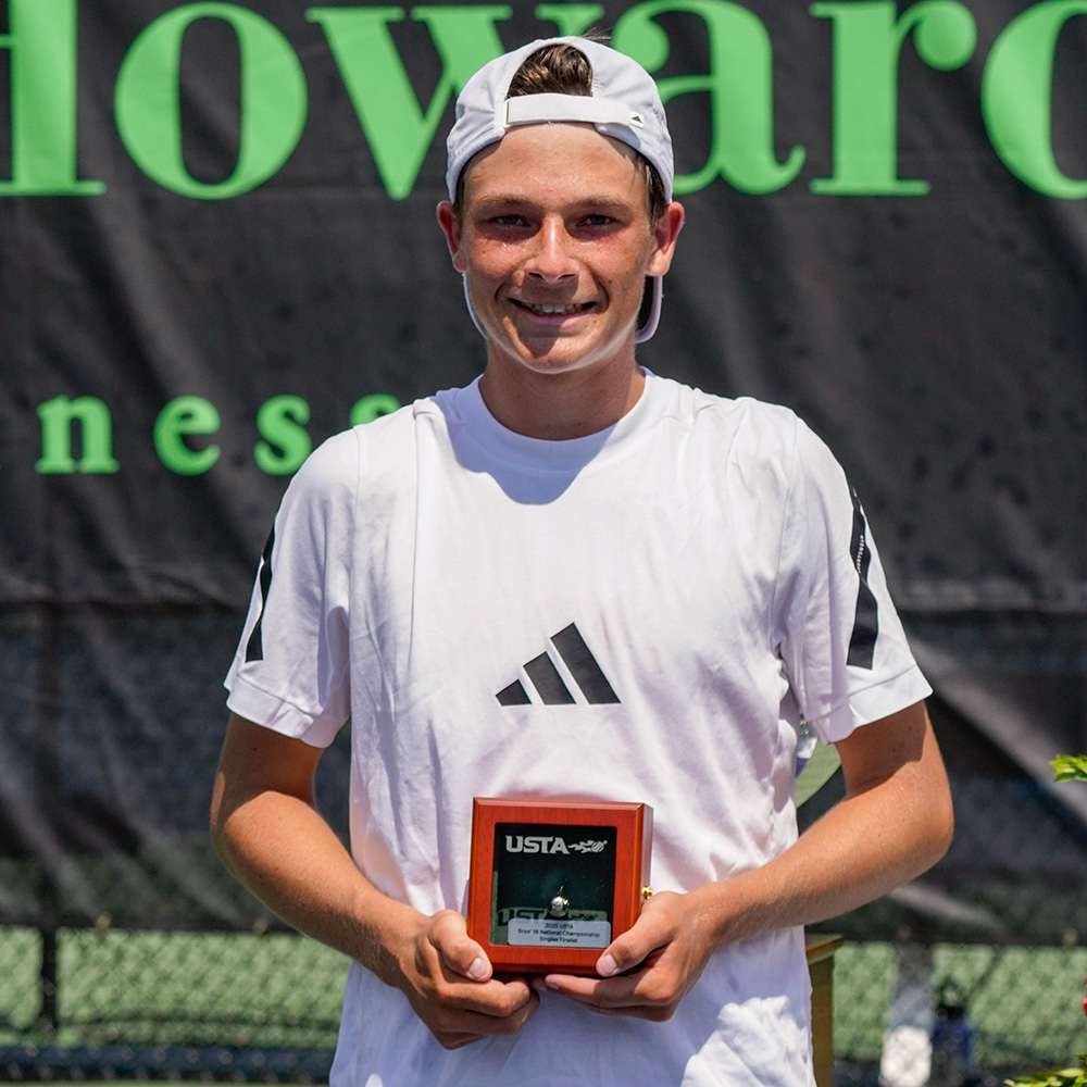 Andy Johnson smiles while holding his USTA Silver Ball trophy at the USTA Boys' 16s Singles National Championships award ceremony in Kalamazoo, Michigan, after finishing second overall.