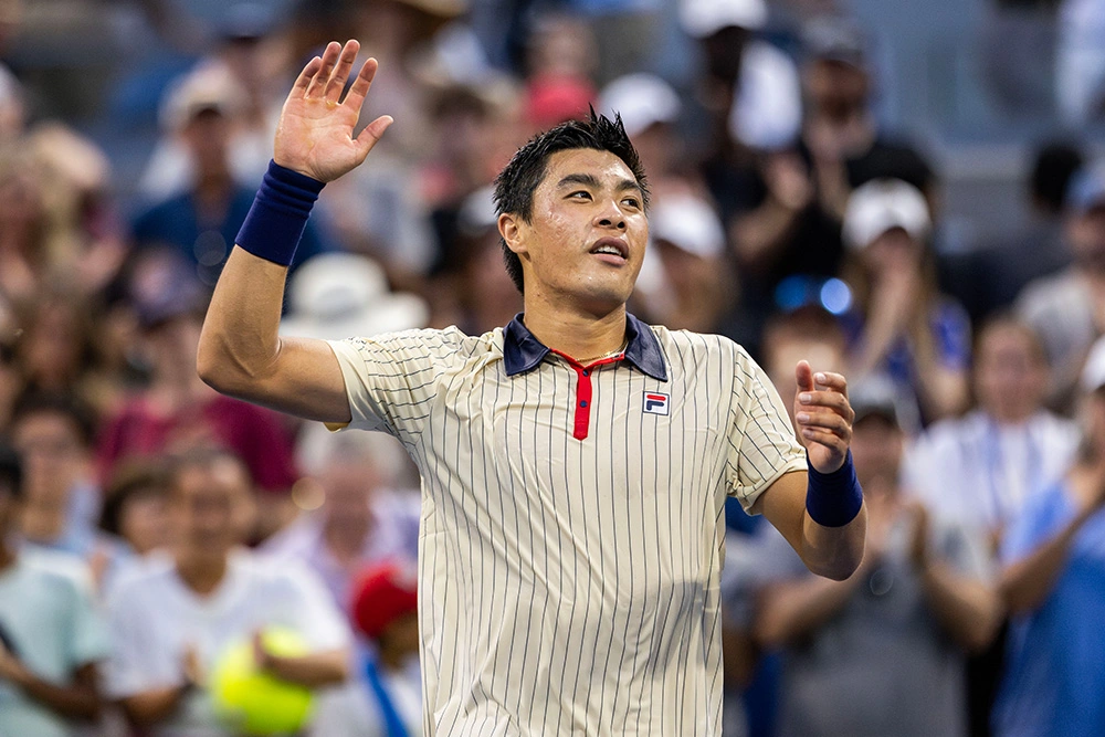 Brandon Nakashima waving to the roaring crowd at the 2024 US Open after defeating Holger Rune.