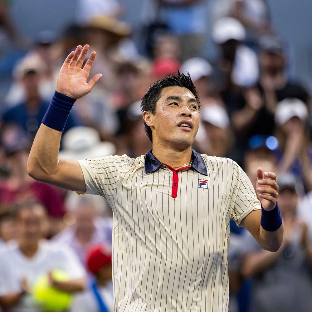 Brandon Nakashima waving to the roaring crowd at the 2024 US Open after defeating Holger Rune.