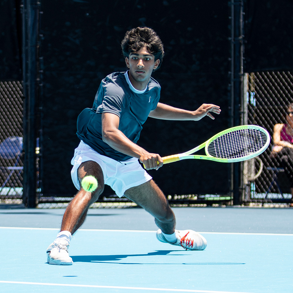 Roshan Santhosh sliding to hit a tennis ball at the SoCal Pro Series at the University of San Diego