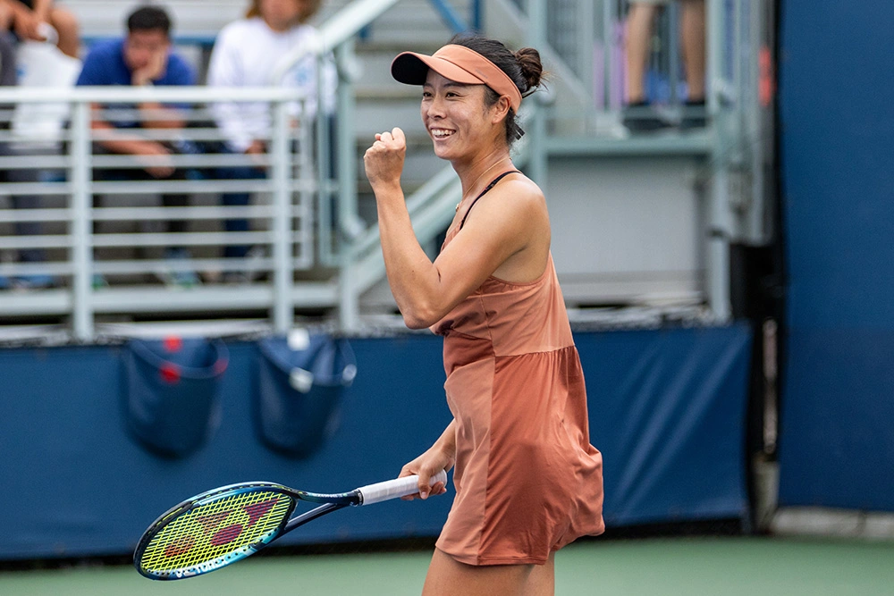 Ena Shibahara smiles and pumps her fist in the air during her 2024 US Open singles match