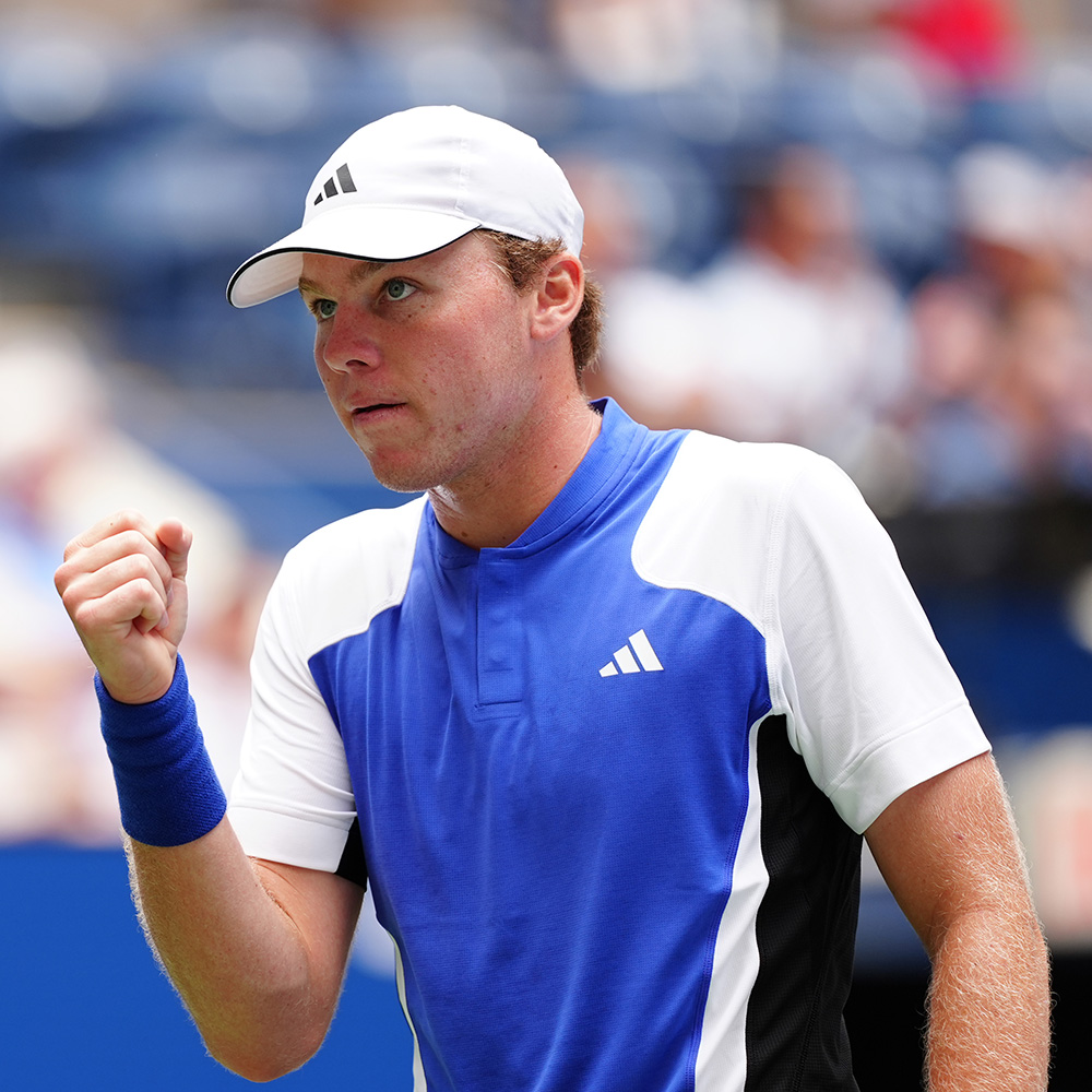 Alex Michelsen pumps his fist during his 2024 US Open match on Arthur Ashe Stadium against Jannik Sinner