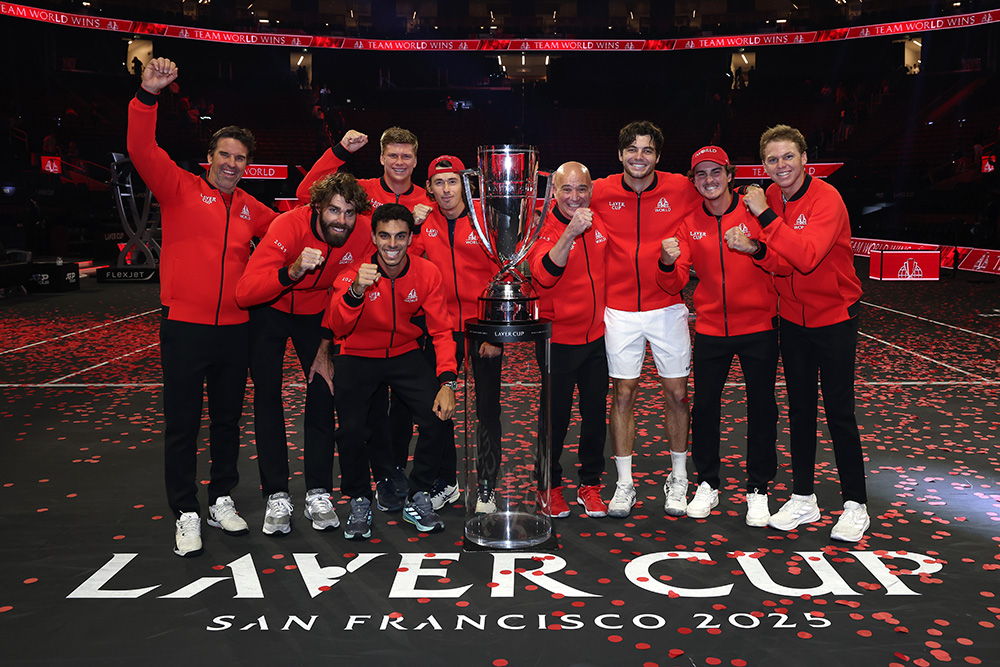 Team World celebrates their 2025 Laver Cup victory, smiling all the way with the trophy in hand.