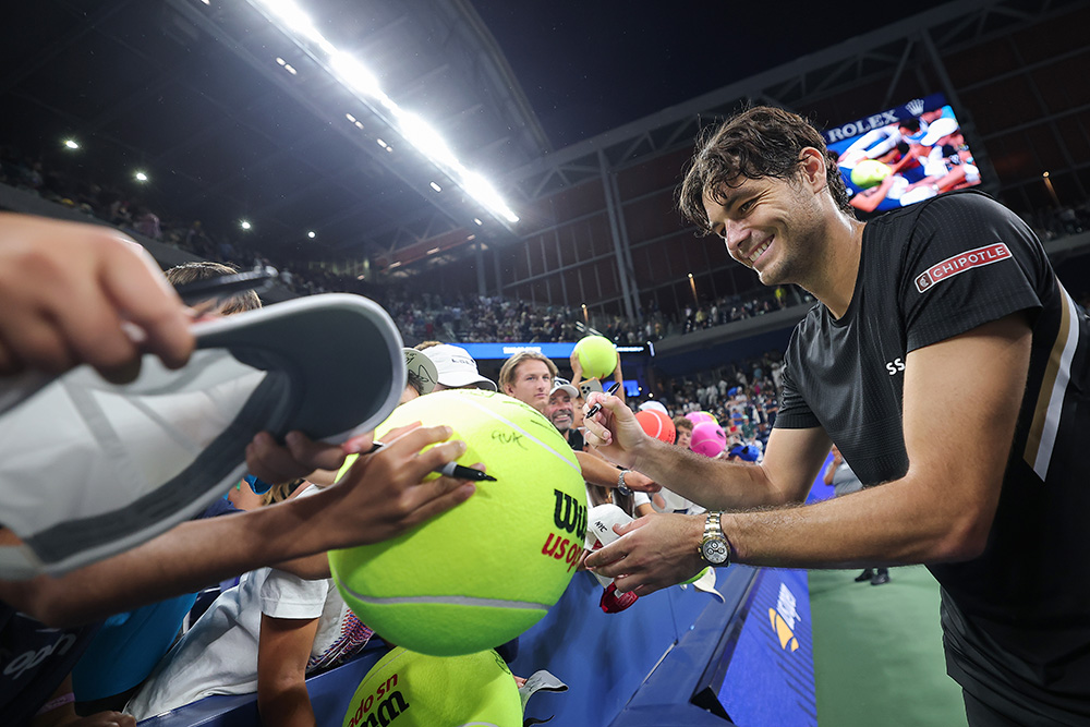Taylor Fritz signs an autograph for fans during a men's singles match at the 2025 US Open on Sunday, Aug. 31, 2025 in Flushing, NY. (Dustin Satloff/USTA)