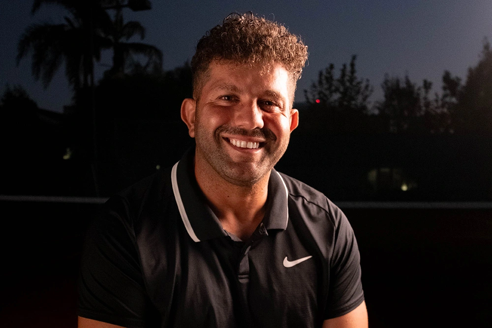 Danny Salloum smiling on the tennis court