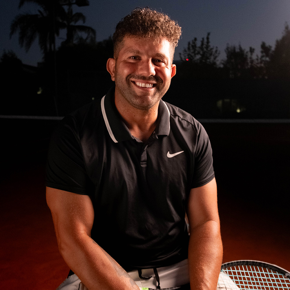 Danny Salloum smiling on the tennis court
