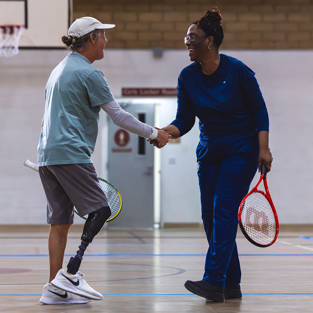 Will Rogers from Indio, California and Marcia Harvey from Vienna, Virginia share a handshake at the Blind and Low Vision Tennis Tournament hosted by USTA Southern California at Wayfinder Family Services.