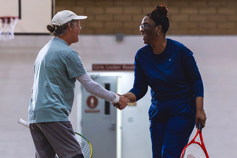 Will Rogers from Indio, California and Marcia Harvey from Vienna, Virginia share a handshake at the Blind and Low Vision Tennis Tournament hosted by USTA Southern California at Wayfinder Family Services.