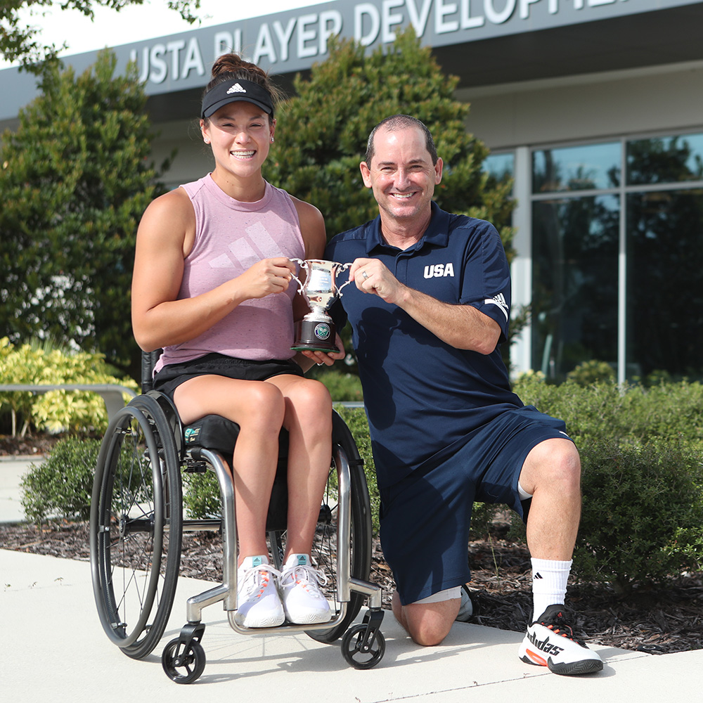 Wheelchair player Dana Mathewson and Jason Harnett pose together inside the USTA Player Development headquarters.