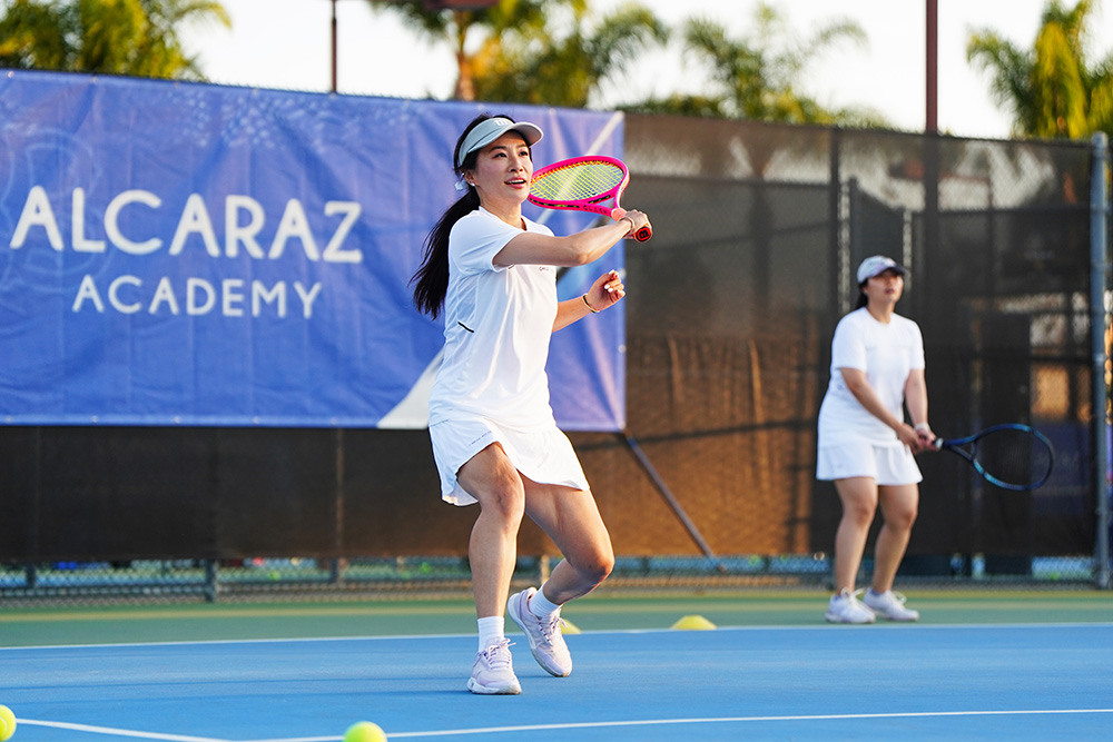Campers hitting at a Carlos Alcaraz Academy Adult Camp in Southern California