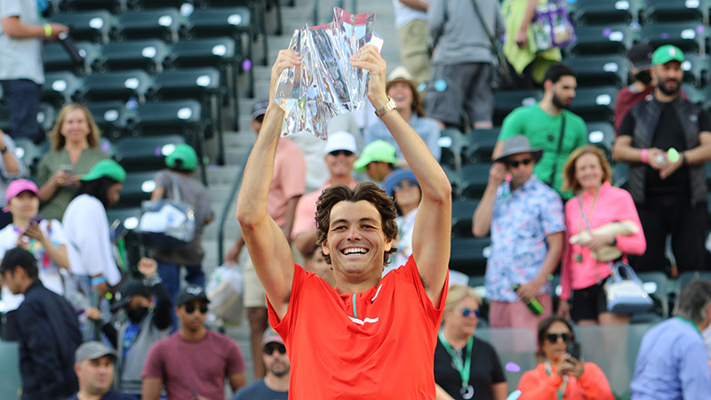 Taylor Fritz hoisting the champions trophy after winning the BNP Paribas Open 2022 against Rafa Nadal
