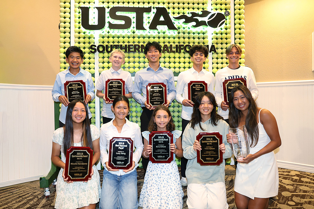 A group of ten award winners smile together at the 2026 USTA Southern California Junior Awards Banquet. They are posing indoors in front of a decorative wall constructed entirely out of green tennis balls beneath a glowing USTA Southern California logo.