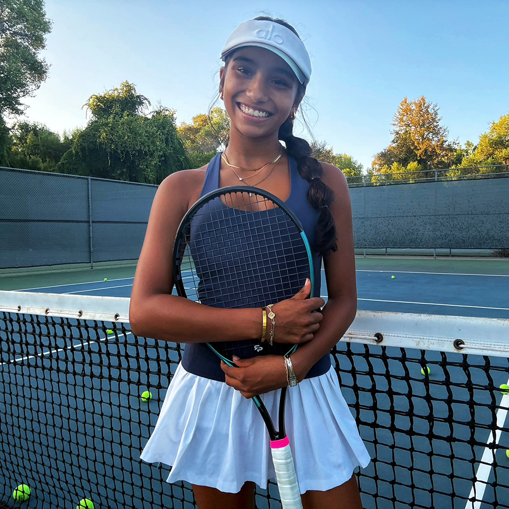 Ava Delgado smiling on the tennis court