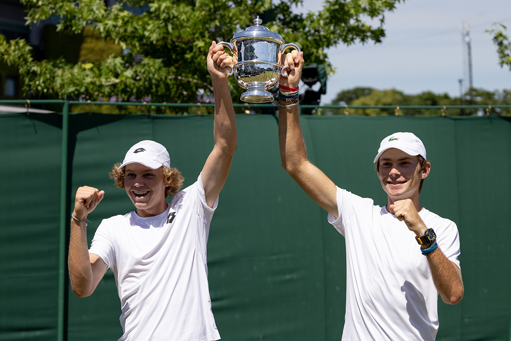 Sebastian Gorzny and Alex Michelsen lift the Boys Australian Open Doubles trophy after defeating Gabriel Debru and Paul Inchauspe on Court 12 at The Championships 2022. Held at The All England Lawn Tennis Club, Wimbledon. Day 13 Saturday 09/07/2022. Credit: AELTC/Dillon Bryden