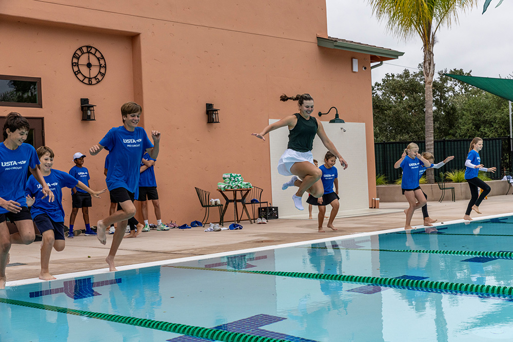 Kayla Day celebrates her Central Coast Tennis Classic victory by jumping into the pool at Templeton Tennis Ranch.