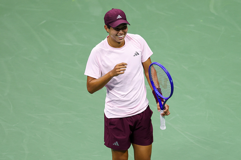 Learner Tien smiles at the US Open.