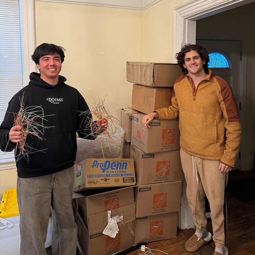 Jakob Esterowitz and Jonah Dickson collecting used tennis strings during their college days at Boston University