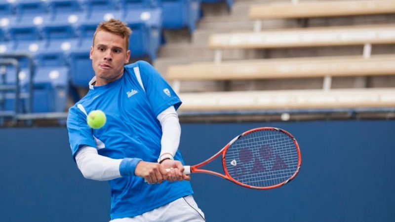 Karue Sell hits a backhand during a UCLA Men's Tennis college match
